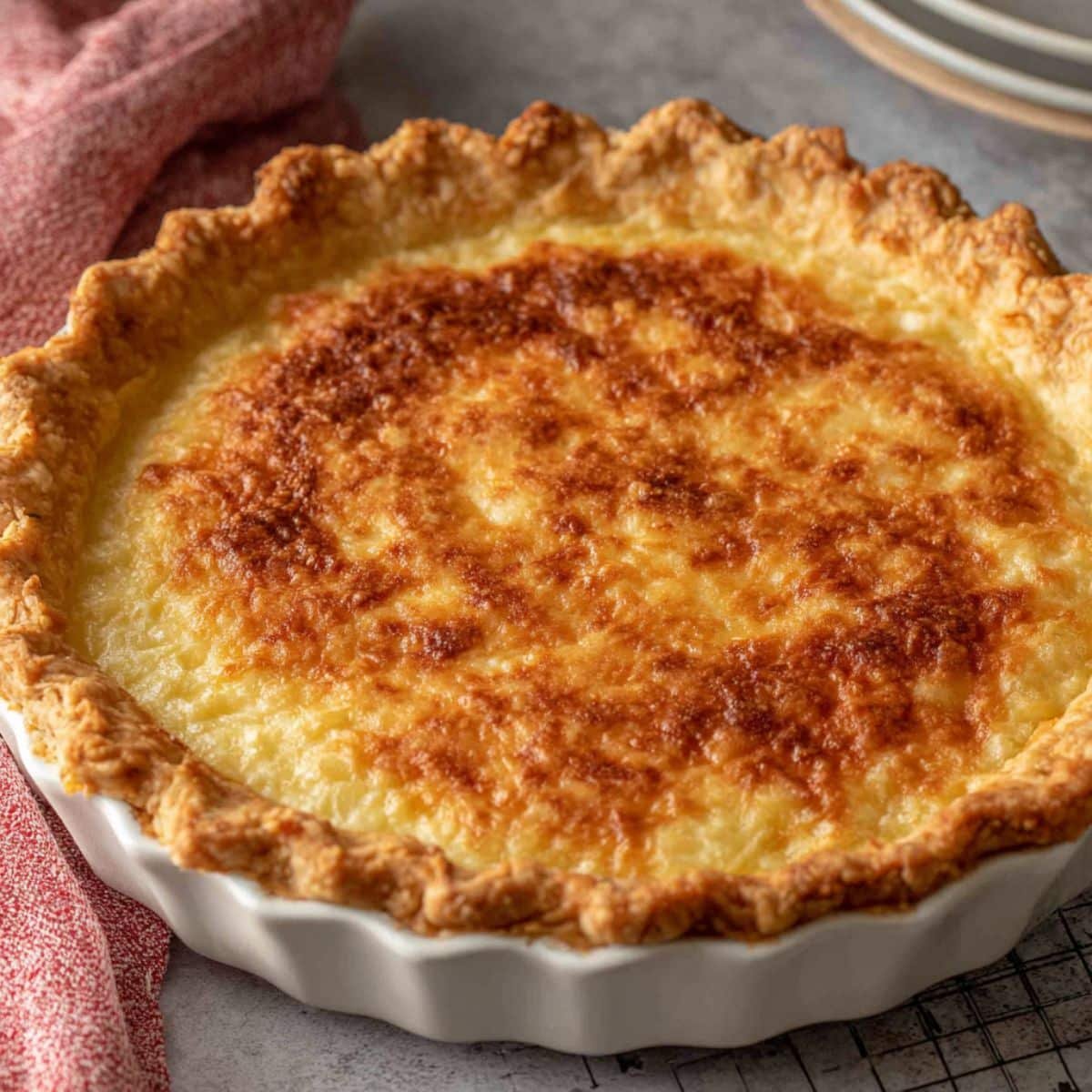 Homemade golden flaky pie crust made with Crisco on a white kitchen table, photographed from above with natural light.