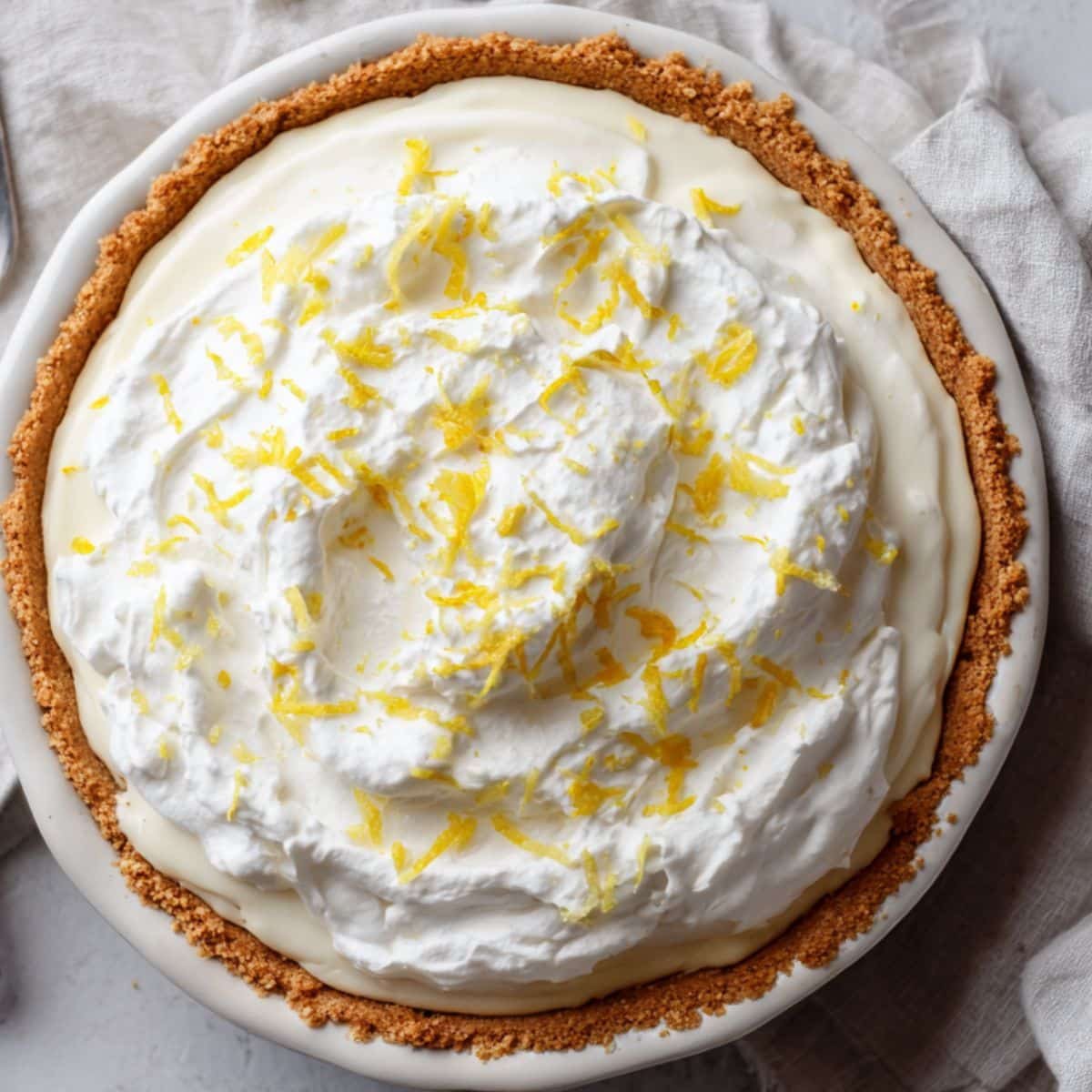 Homemade lemon pie on white kitchen counter.