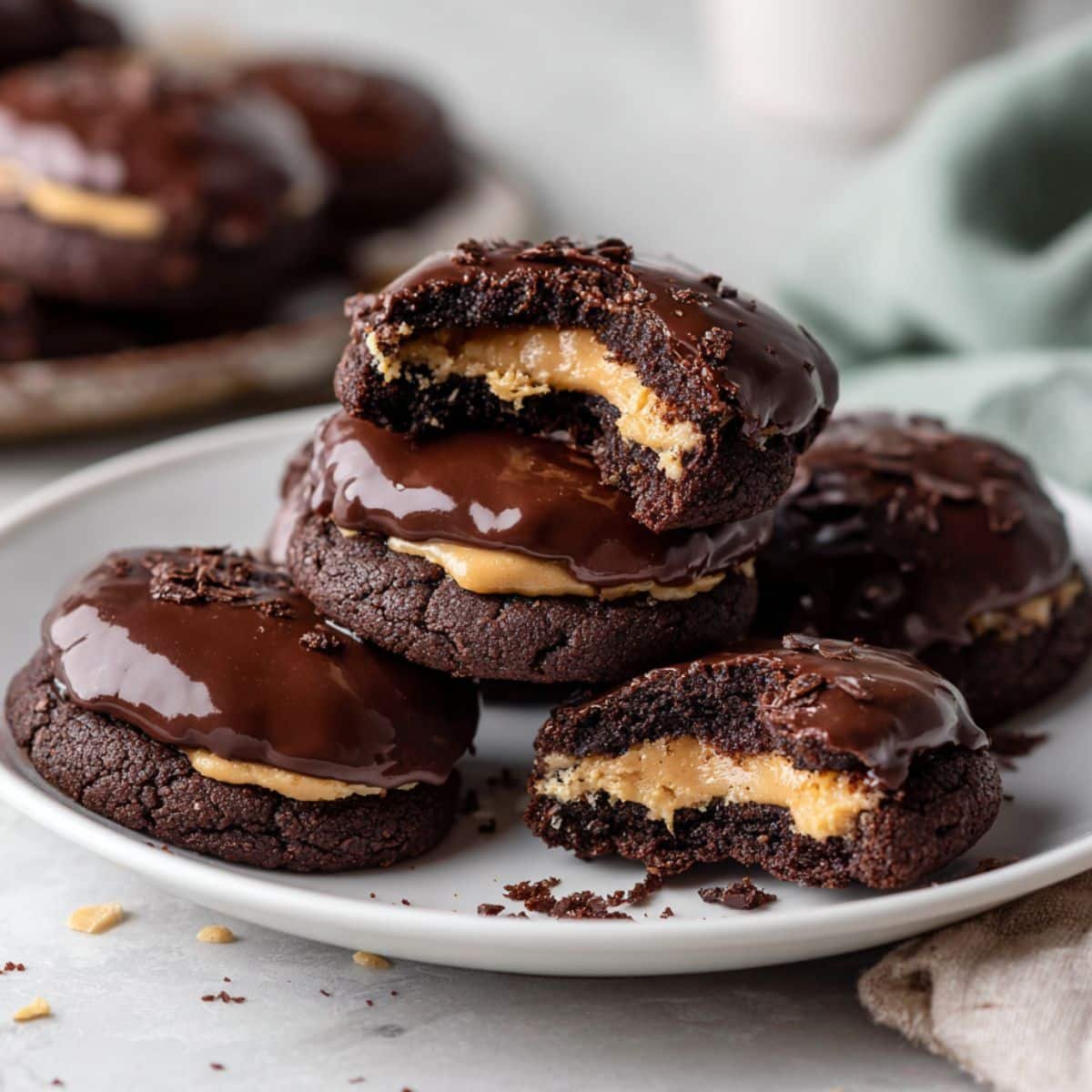 Homemade buckeye brownie cookies on a white kitchen table, showing their fudgy chocolate texture and creamy peanut butter center.