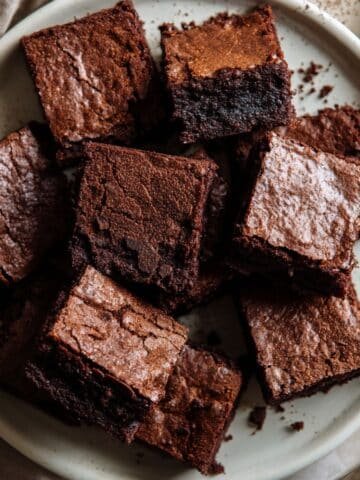 Homemade sugar free brownies cut into rustic squares on a white plate, photographed from above in natural light.
